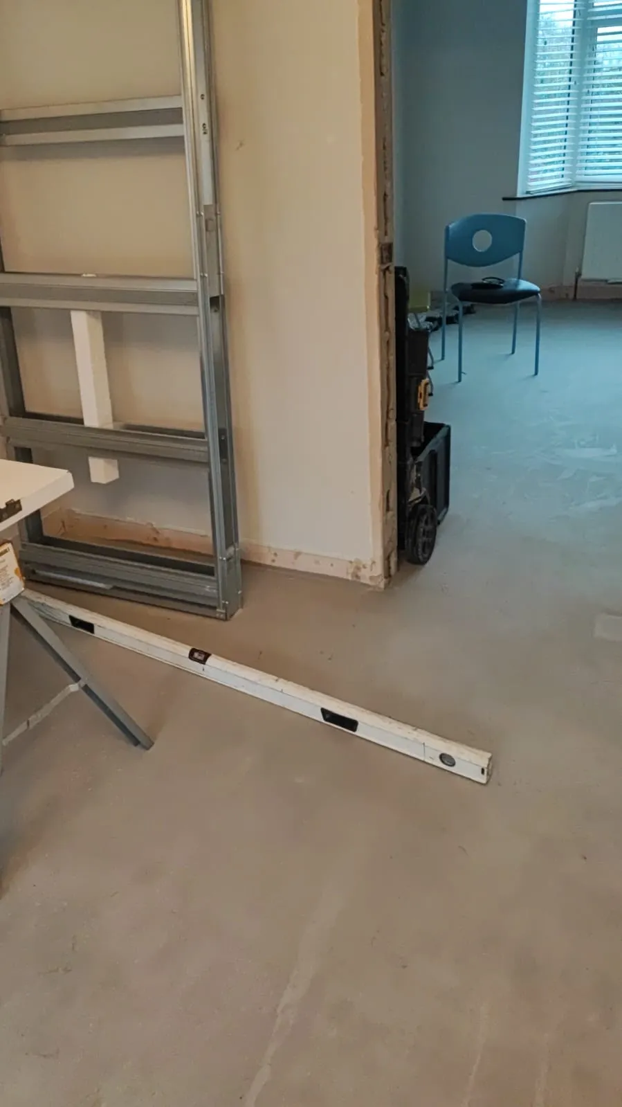 Specialist joiner fitting hardwood door frame and second fix detail on a renovation, Co. Louth
