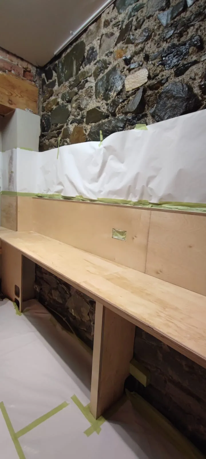 Older fitted kitchen with worn cabinet doors and damaged worktops in an Irish home